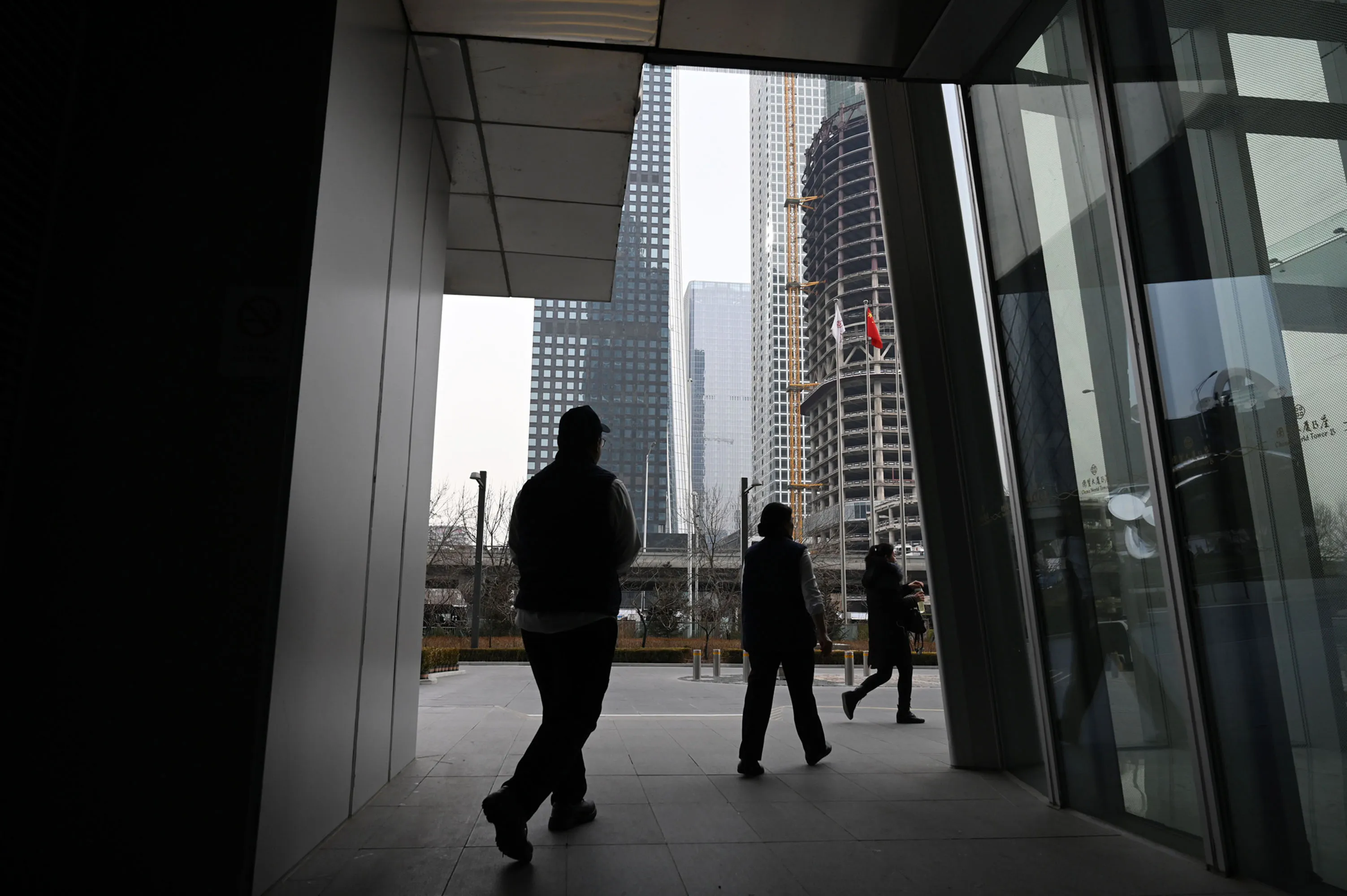 People walk out of a building in Beijing's central business district.