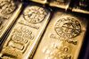 A five hundred gram gold bar, left, and a a one kilogram gold bar, produced by Swiss manufacturer Argor Hebaeus SA, sit in a storage tray in this arranged photograph at Aranypiac Kft in Budapest, Hungary.