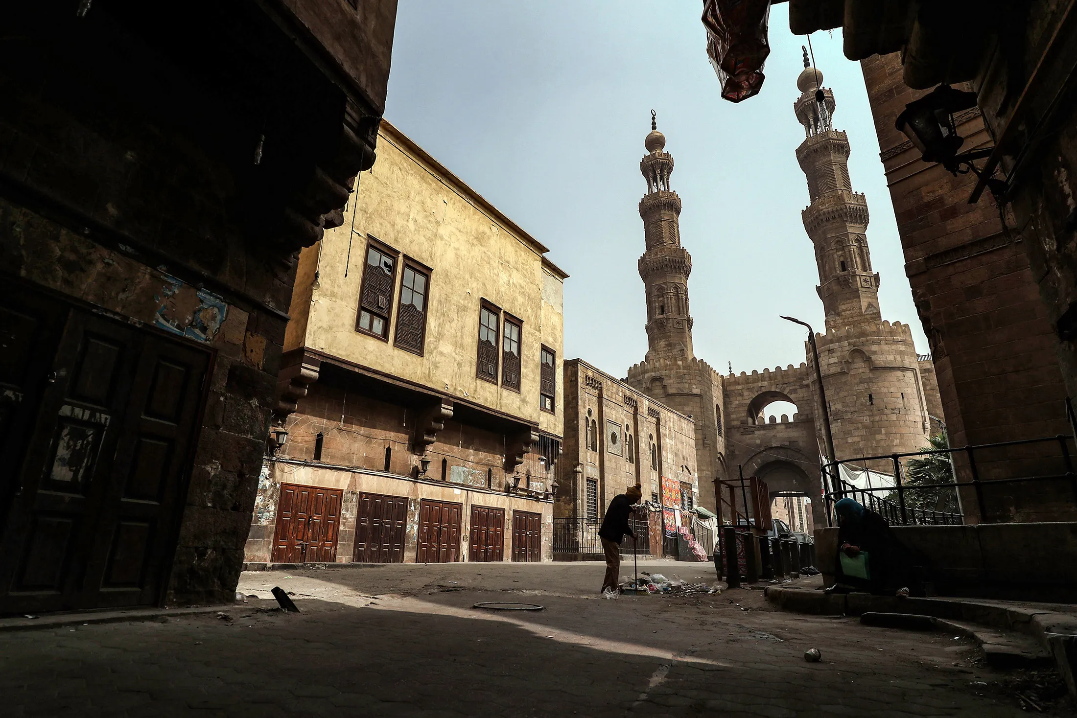 A person sweeps&nbsp;a street in the area around Bab Zuweila, one of the remaining gates in the walls of the old medieval city of Egypt's capital Cairo, on April 24.