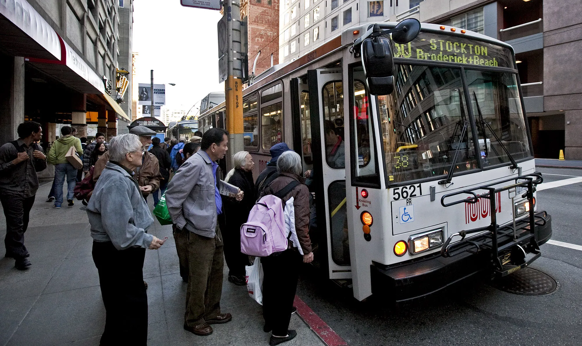 A Muni bus picks up passengers in San Francisco.
