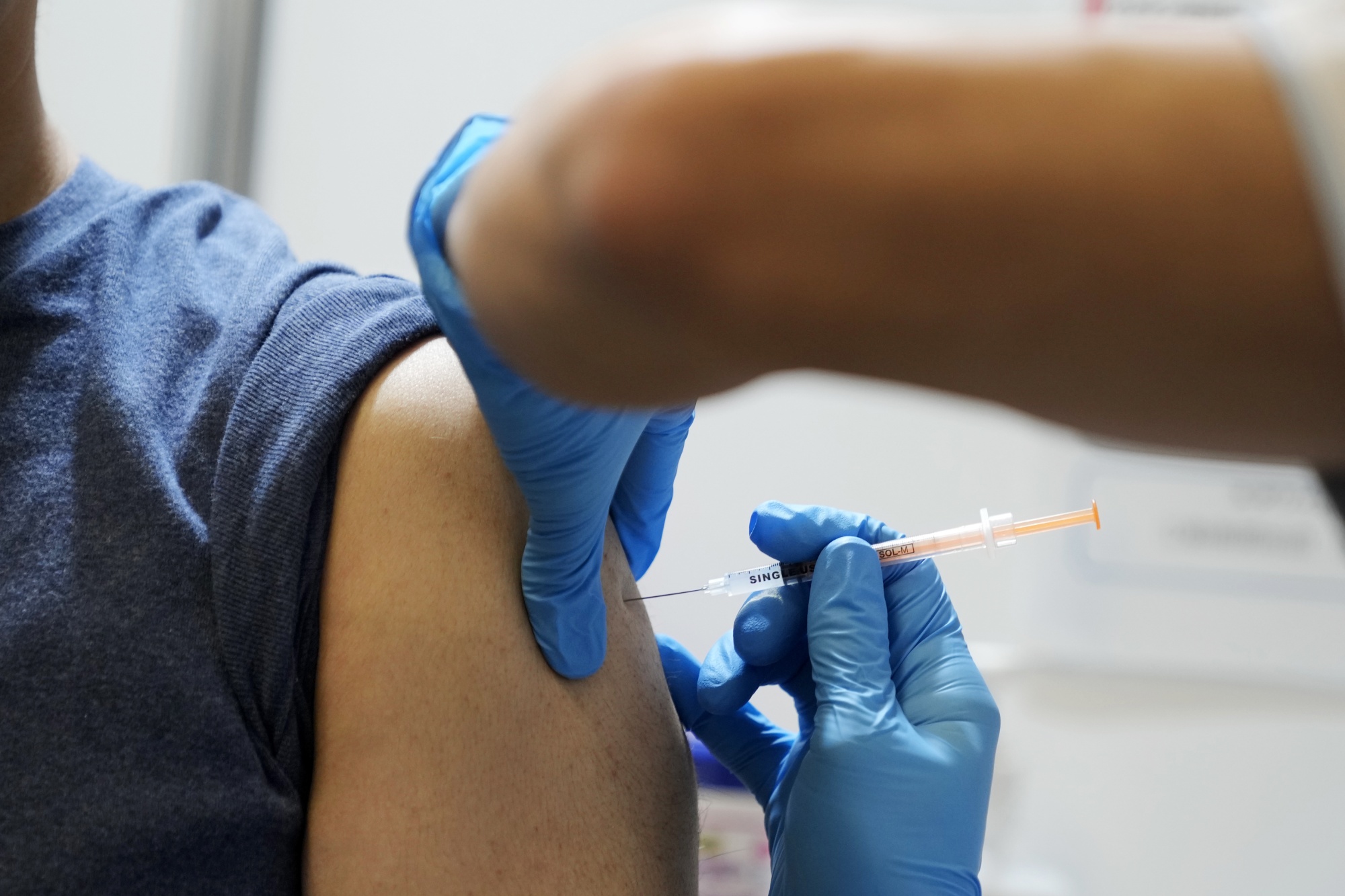 A healthcare worker administers a Moderna Covid-19 vaccine booster shot at a mass vaccination site in Tokyo on Jan. 31.&nbsp;