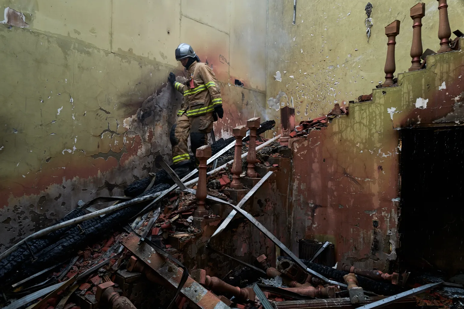 A firefighter descends the stairwell of a burned hotel following a Russian Shahed drone strike&nbsp;in Odesa, Ukraine on April 30.&nbsp;