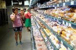 Residents buy groceries at a supermarket in Melitopol in Zaporizhzhia region.