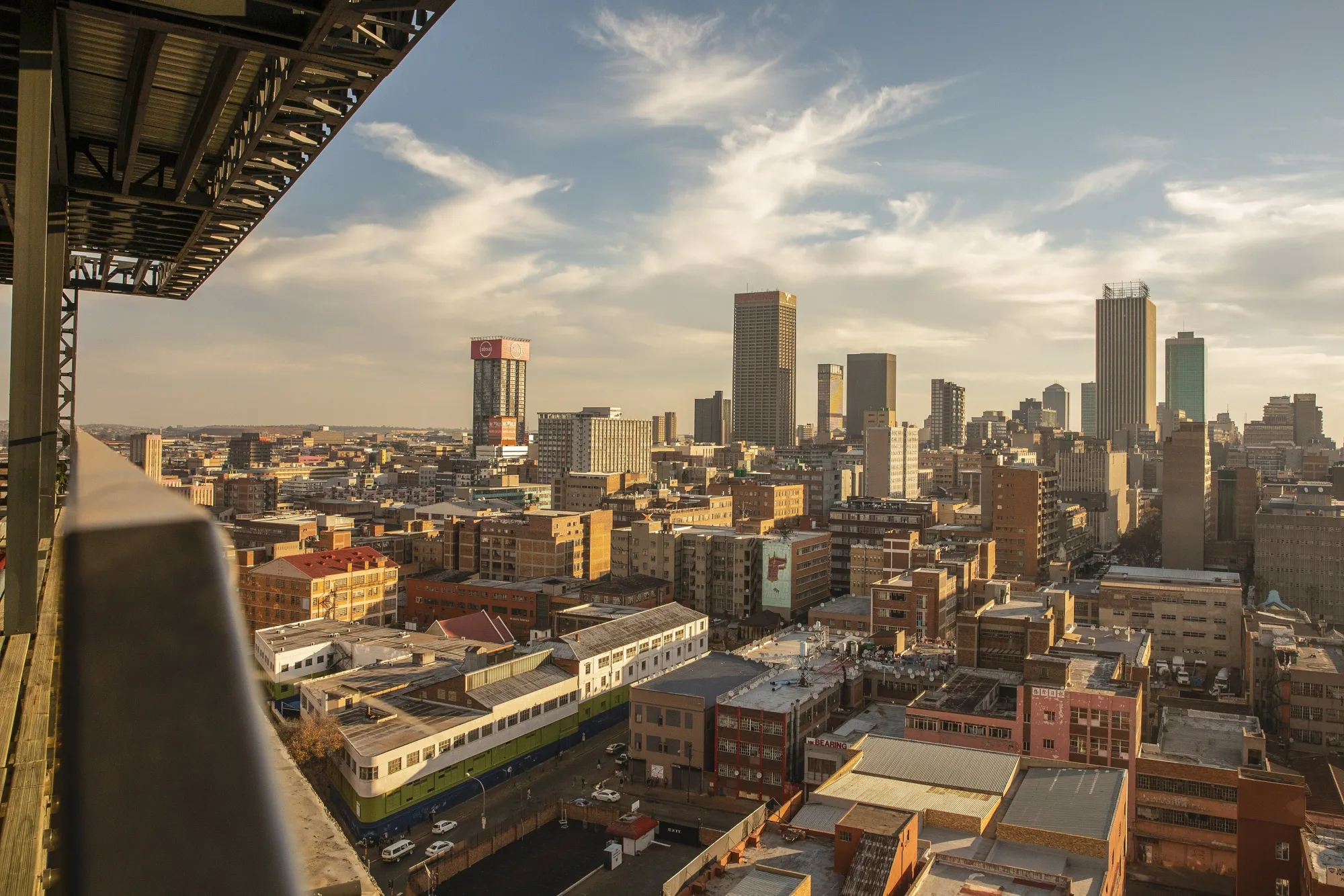 Commercial properties, residential buildings and skyscraper offices on the skyline viewed from a rooftop bar in Johannesburg, South Africa.