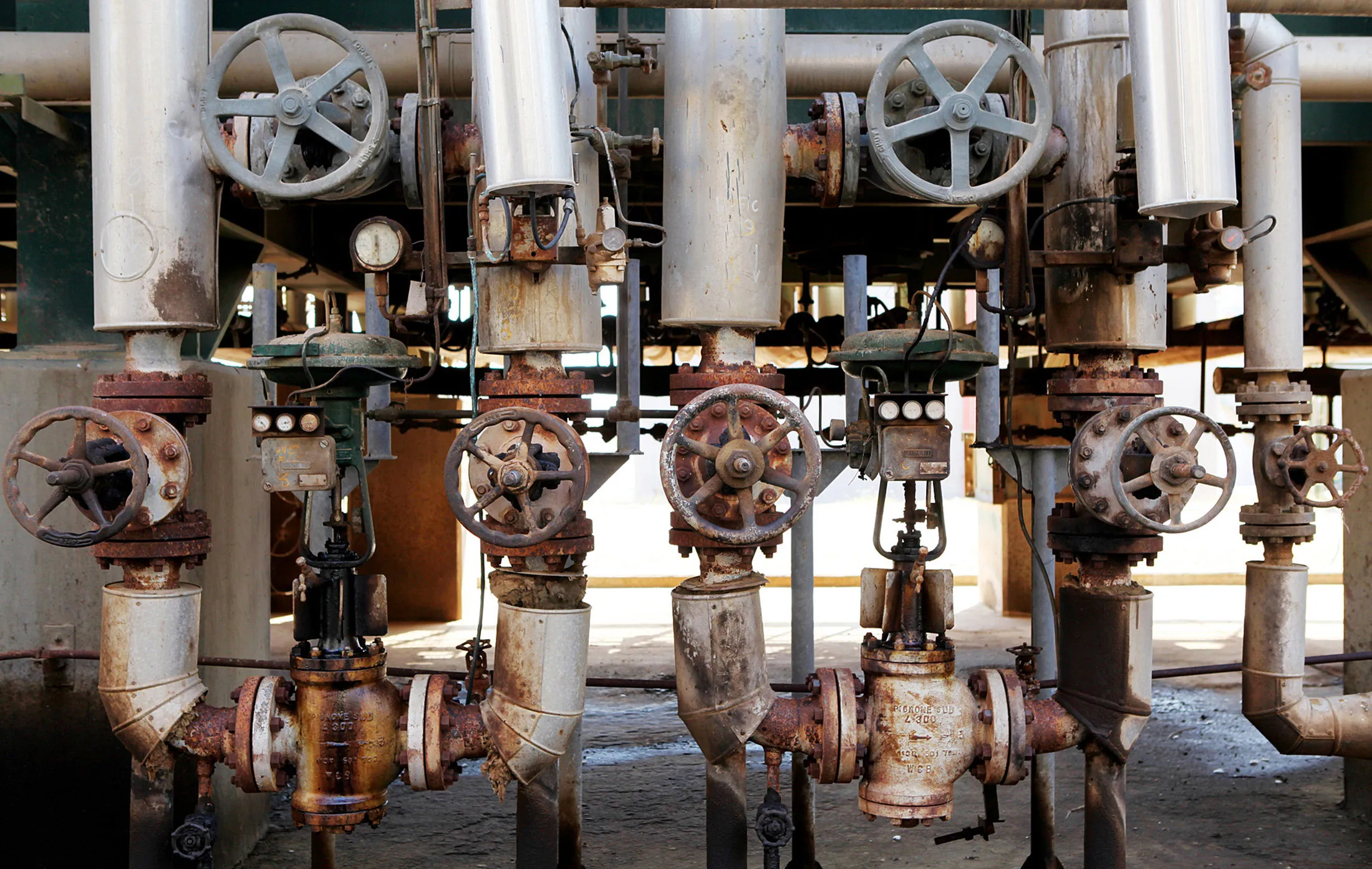 Valve control wheels are seen on pipes at the Zawiya oil refinery near Tripoli, Libya, on Monday, Aug. 29, 2011.
