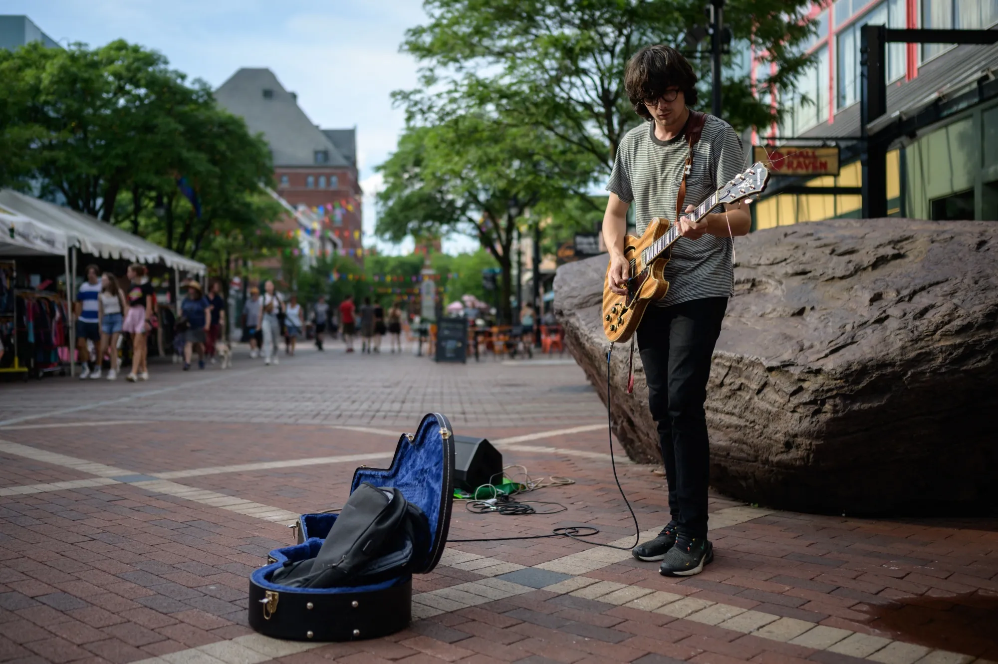 A musician plays guitar on the&nbsp;popular Church street&nbsp;in Burlington, Vermont, on June 28, 2021.