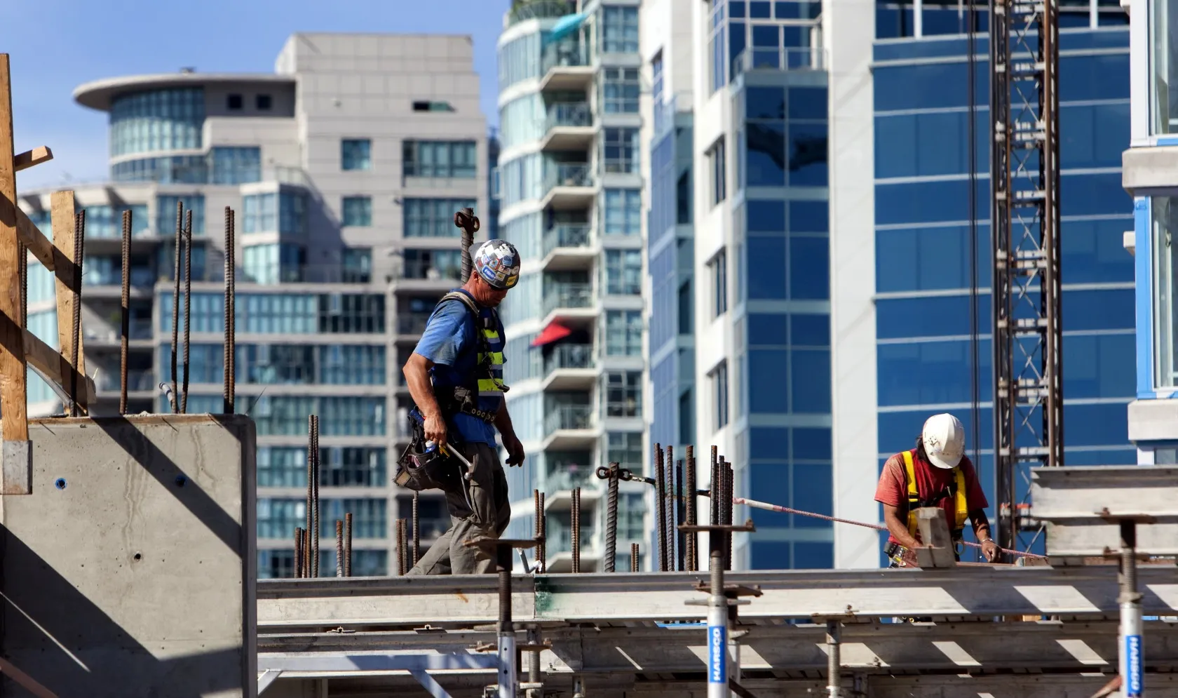 Contractors work a condominium under construction in downtown Vancouver, British Columbia.