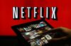 A man scrolls through a selection of viewing choices on the Netflix Inc. application on a tablet device in this arranged photograph in London, U.K