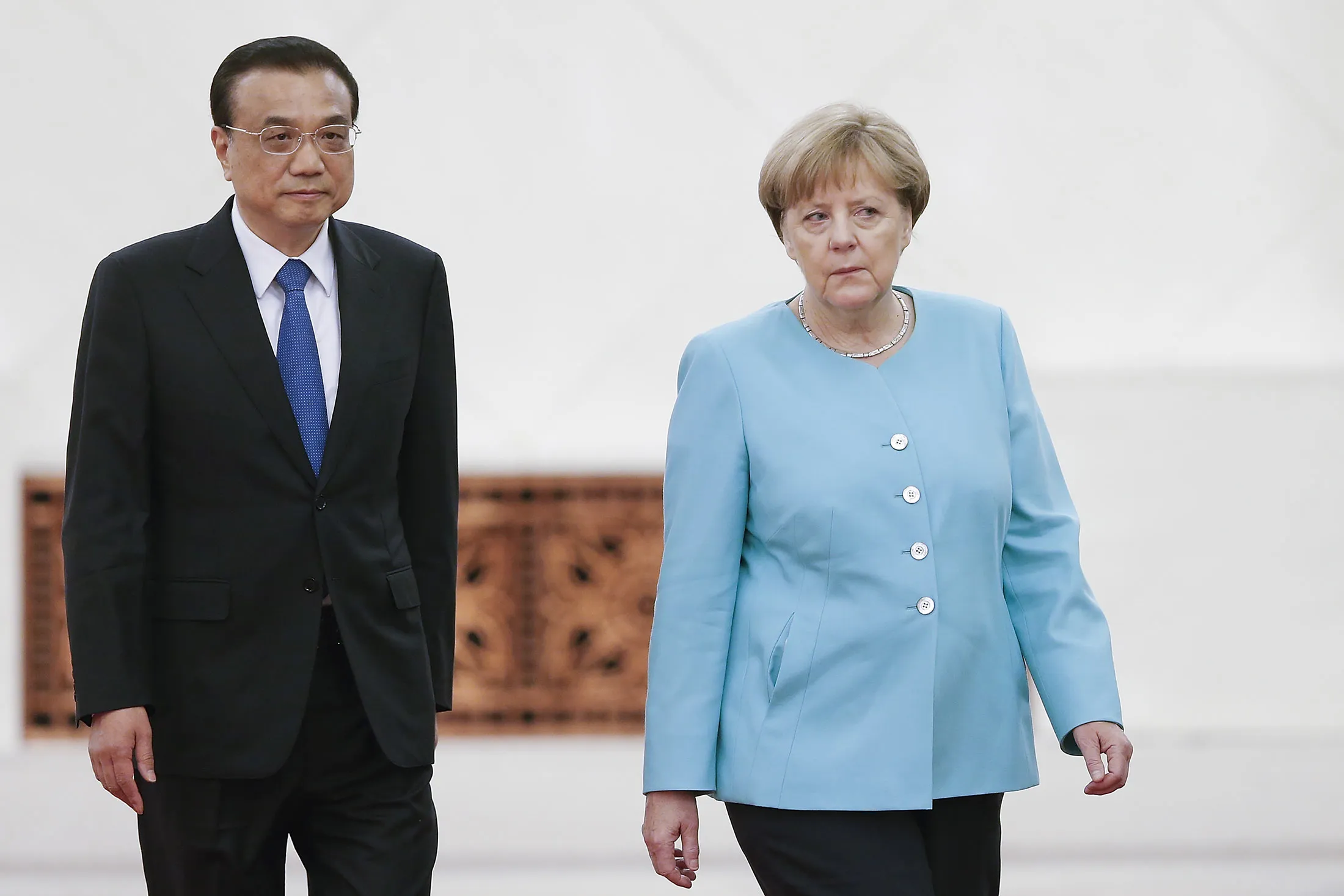 Chinese Premier Li Keqiang and German Chancellor Angela Merkel attend a welcoming ceremony at the Great Hall of the People on June 13, in Beijing.
