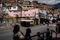 Children pass by in front of a mural of President Maduro, at the entrance of the José Félix Ribas neighborhood, in the Petare Slum