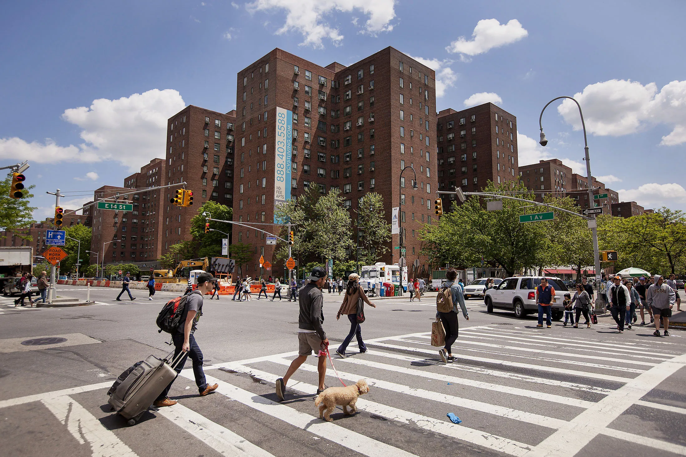 Pedestrians cross the street in front of Stuyvesant Town.
