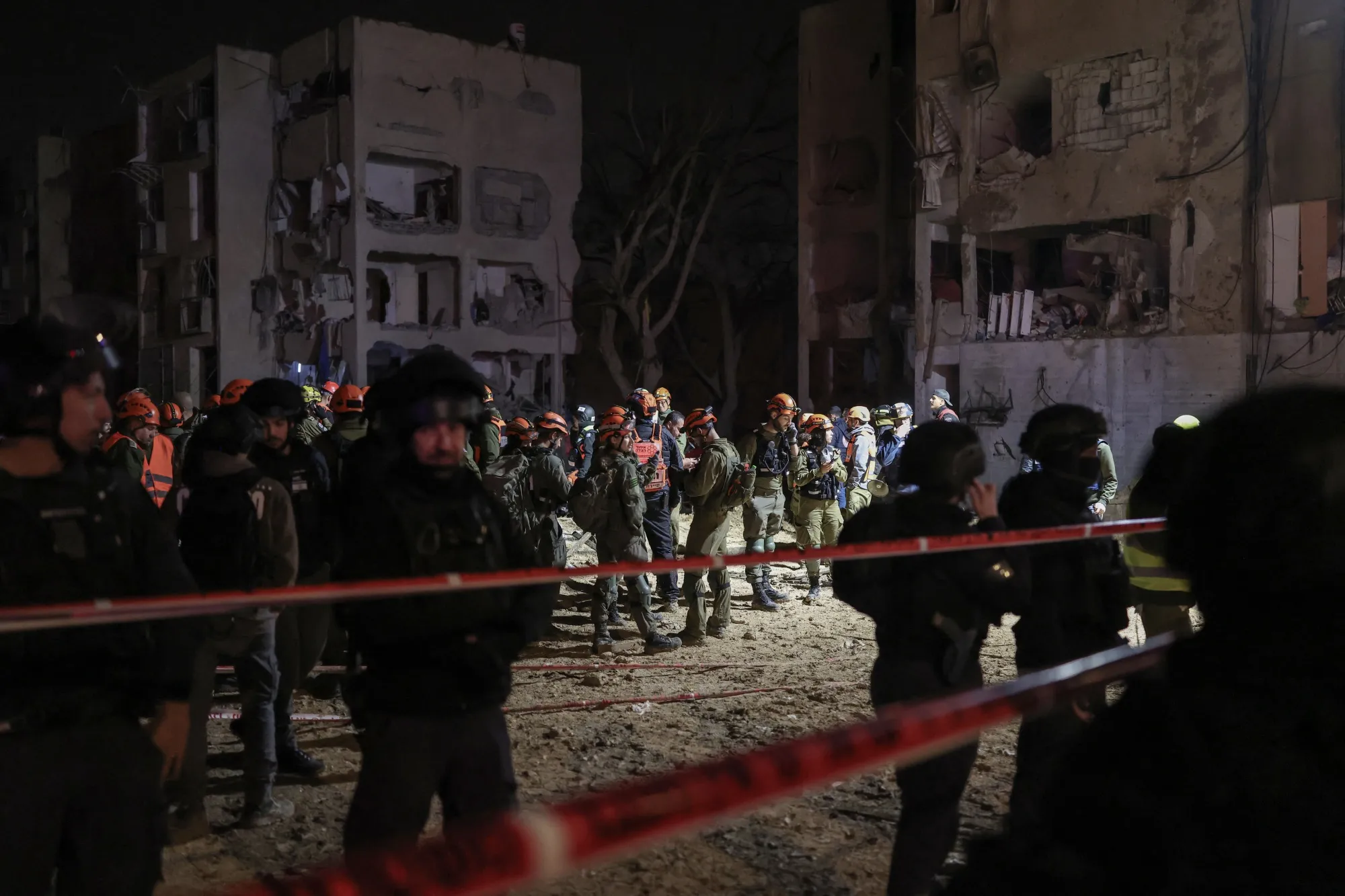 First responders inspect the site of an Iranian missile strike in Arad, Israel, early on March 22.