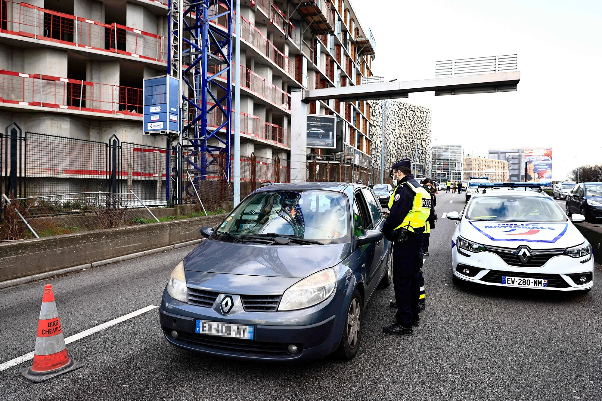 A police officer controls and filters vehicles as they arrive at Porte d'Orleans in southern Paris on Feb.&nbsp;11.&nbsp;