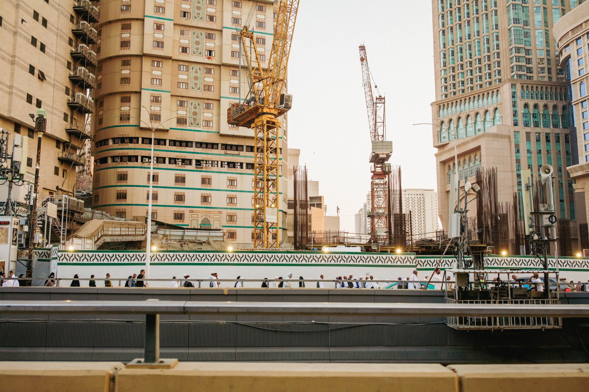 Pilgrims walk past high rise hotels and construction cranes on the way to to the Grand Mosque. Bloomberg