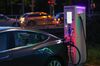 A Tesla Inc. Model 3 electric automobile sits charging at an electric vehicle refueling site.