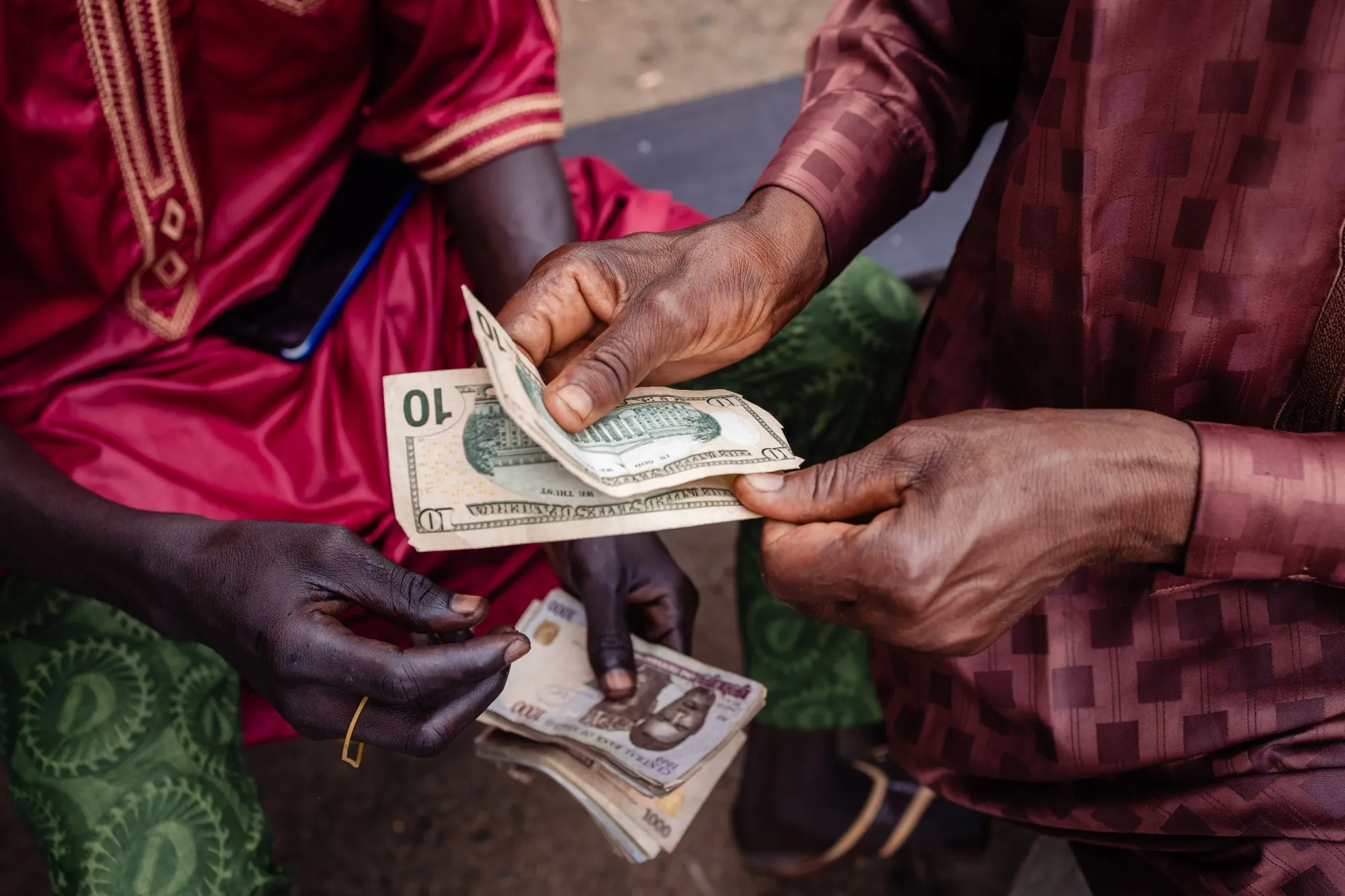 A currency dealer exchanges notes at a market in Lagos, Nigeria.