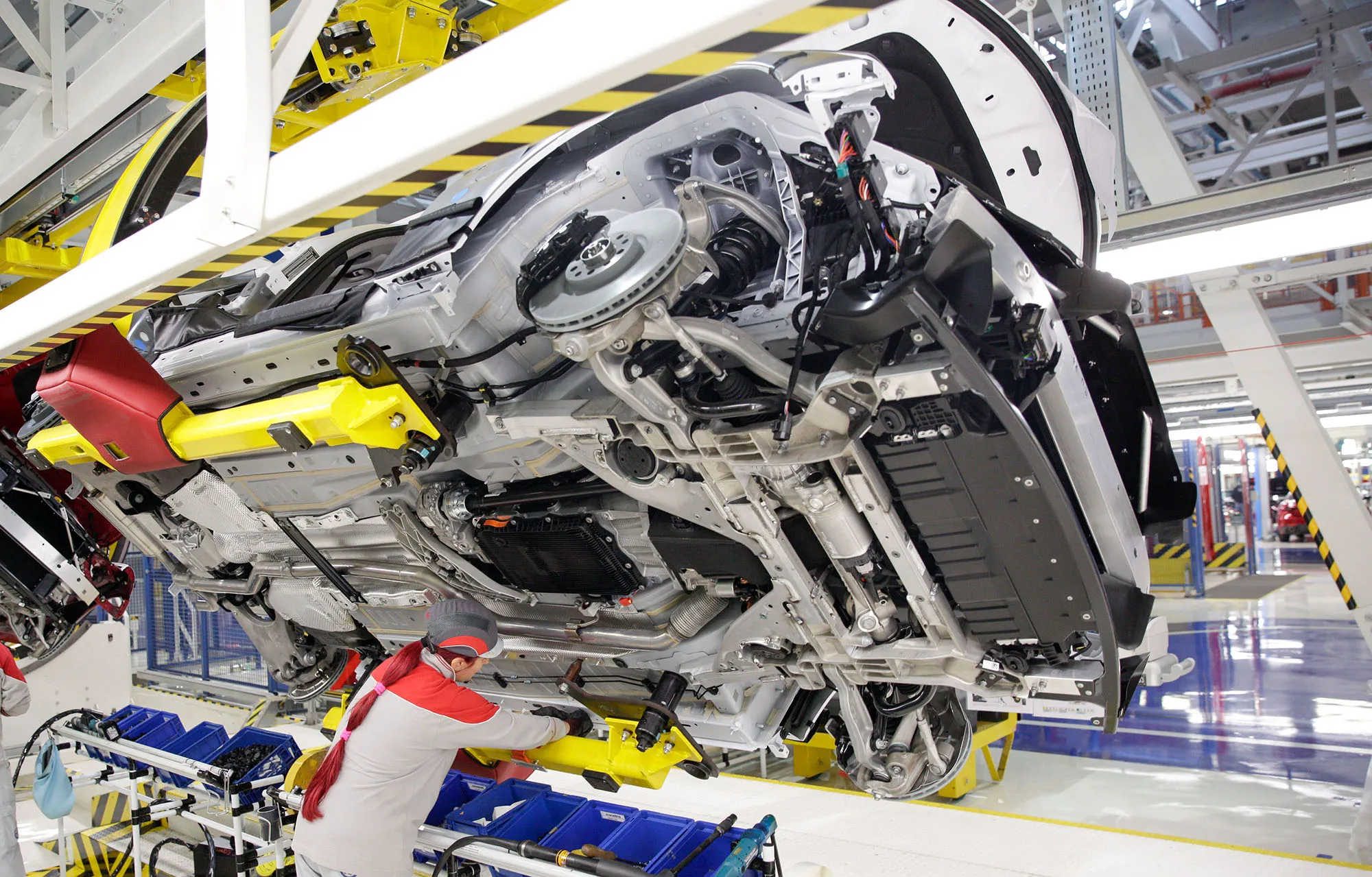 An employee working&nbsp;on an Alfa Romeo Giulia sports car on a factory production line in Cassino, Italy.
