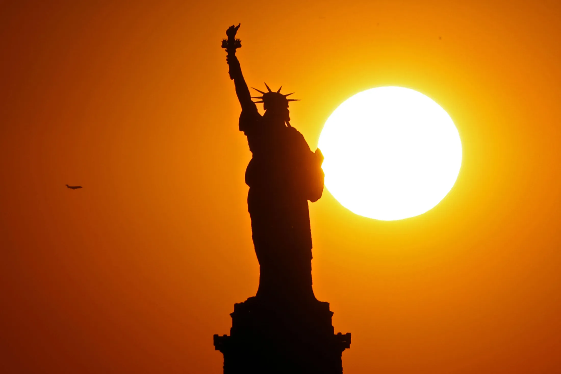 The Statue of Liberty at sunset.

