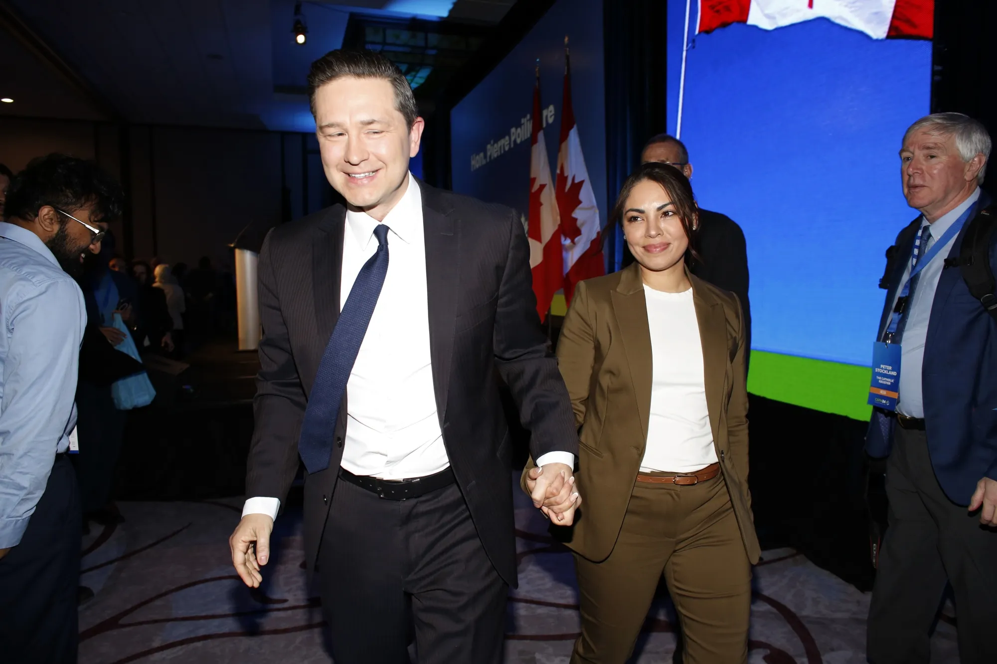 Pierre Poilievre, leader of Canada’s Conservative Party, walks off stage with his wife, Anaida Poilievre, during a political conference in Ottawa earlier this year.