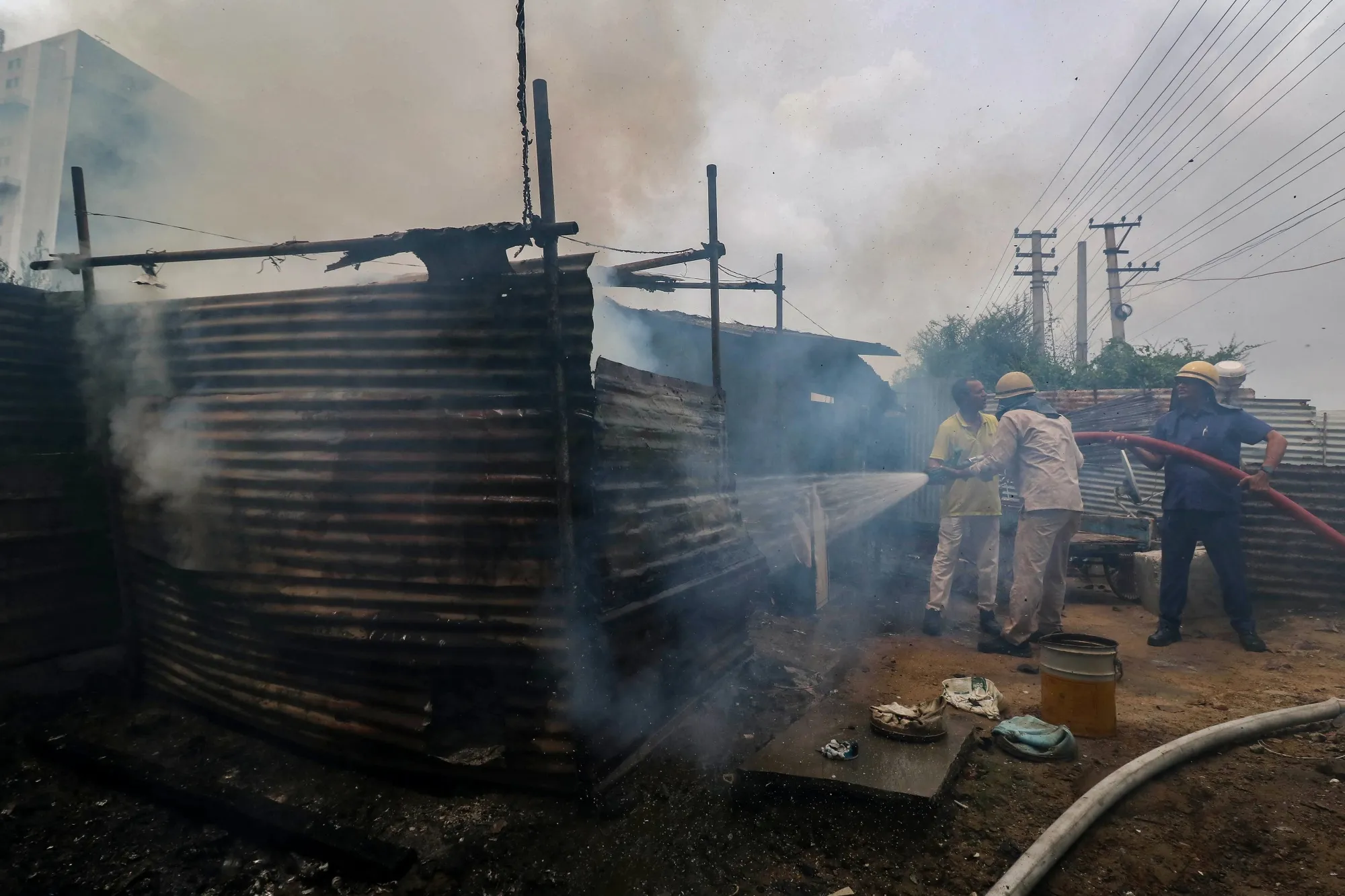 Firefighters douse a fire following clashes in Manesar, Haryana, on Aug. 2.