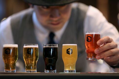 A bartender arranges glasses of craft beer for a photograph at a Spring Valley Brewery brewpub in Yokohama, on march 35, 2015. Photographer: Yuriko Nakao/Bloomberg