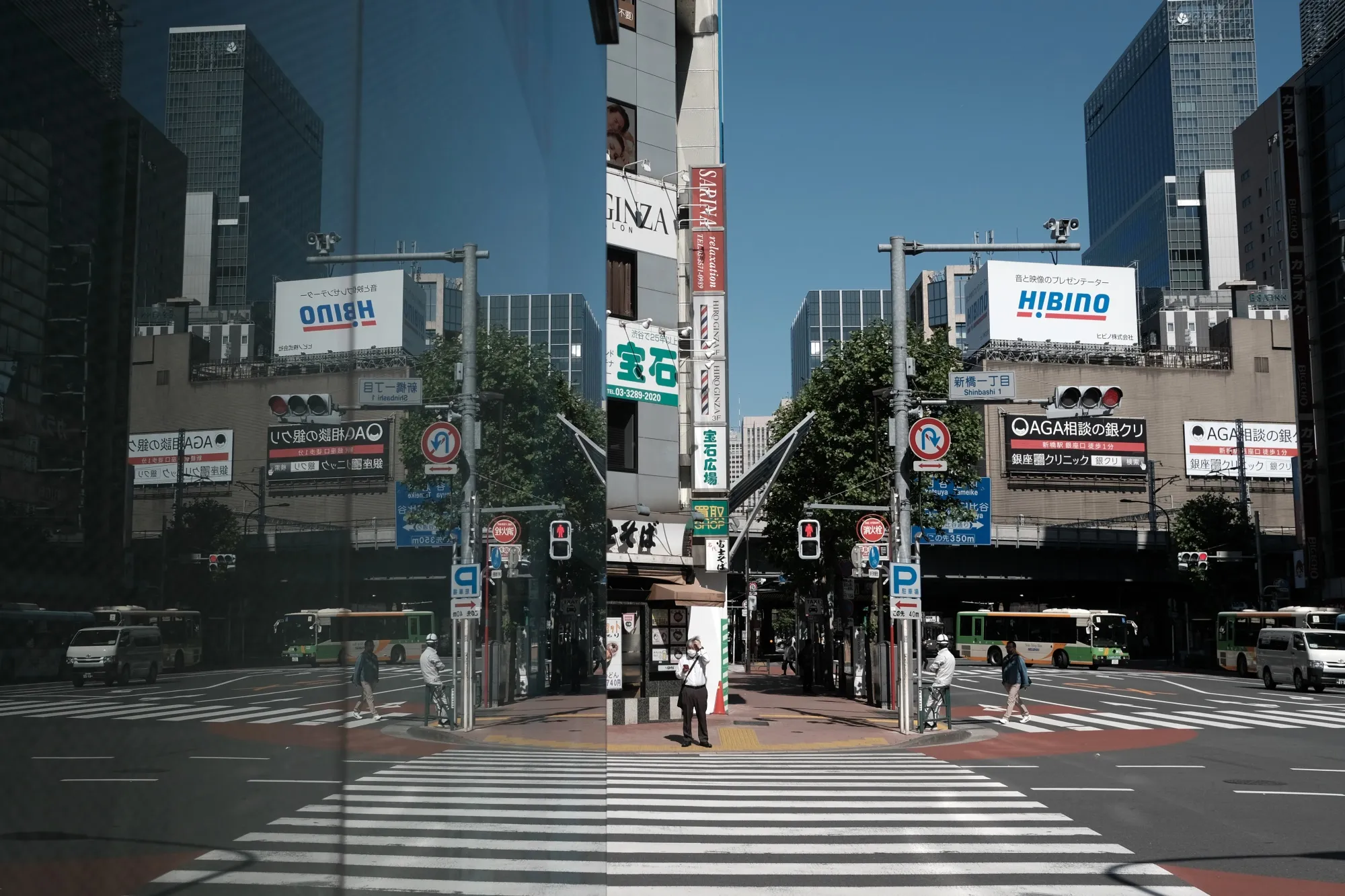 A pedestrian stands at crossing in the Shimbashi district in Tokyo on May 14.