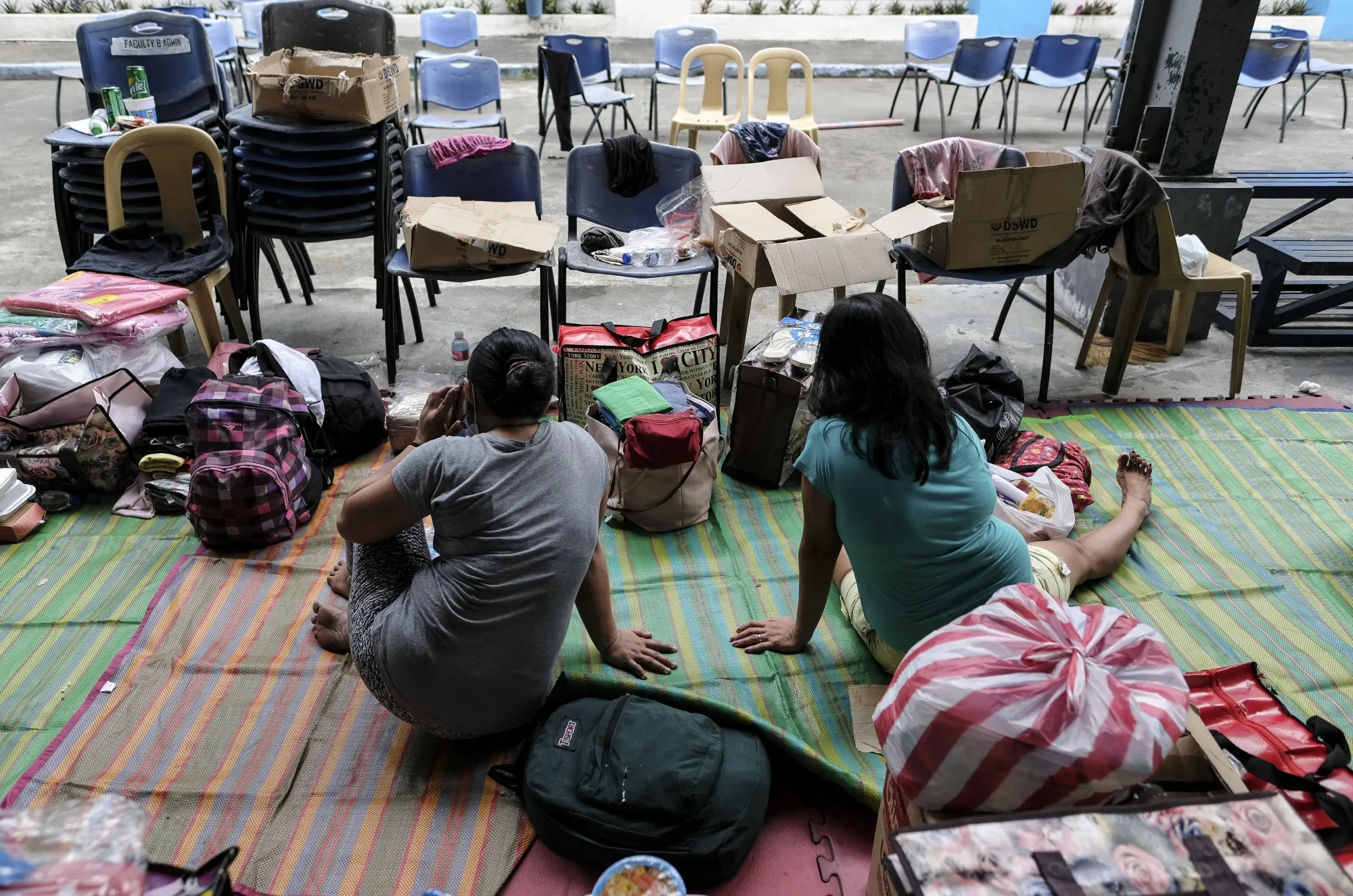 Overseas Filipino workers (OFW) stranded due to reduced flights stay at a temporary shelter set up in a school in Pasay City, Metro Manila.