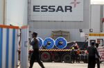 Workers load items onto a truck at the Essar Steel&nbsp; Pune Facility near Pune in Maharashtra, India.