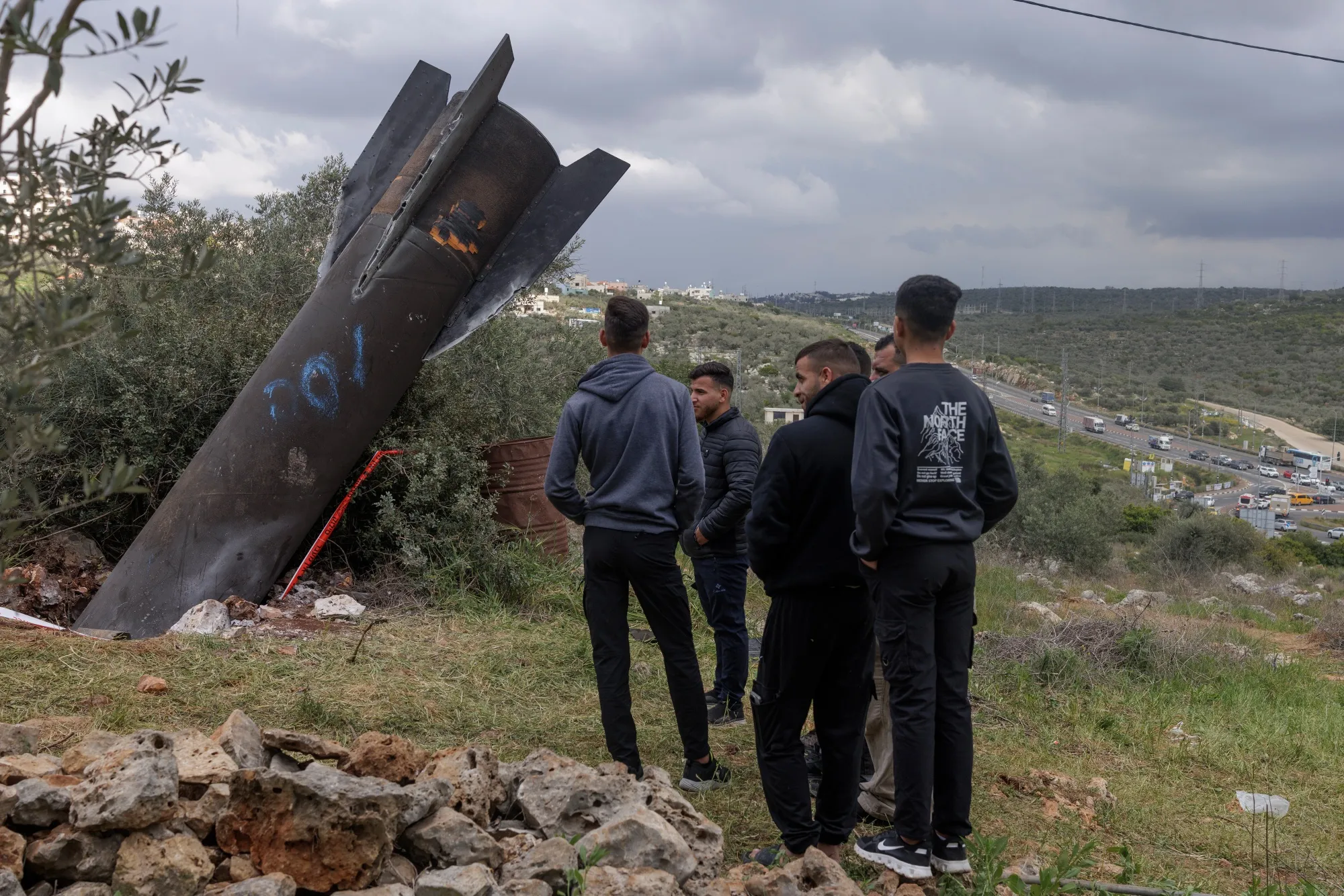 Palestinians inspect the wreckage of an Iranian missile in Kifl Haris, West Bank