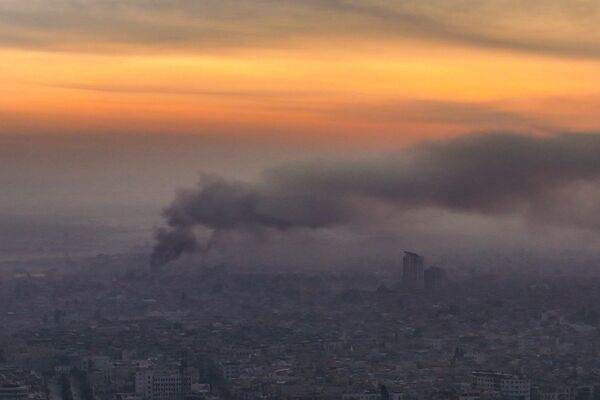 Smoke rises following an air strike in Damascus on Dec. 10.