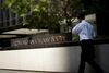 Pedestrians pass in front of the JPMorgan Chase & Co. headquarters in New York, U.S., on Friday, July 6, 2012.