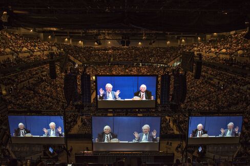 Buffett and Munger appear on screens in Omaha, on May 2, 2015.