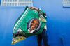 A street vendor sells regalia depicting South African President Cyril Ramaphosa in Durban on Jan. 12, 2019.