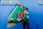 A street vendor sells regalia depicting South African President Cyril Ramaphosa in Durban on Jan. 12, 2019.