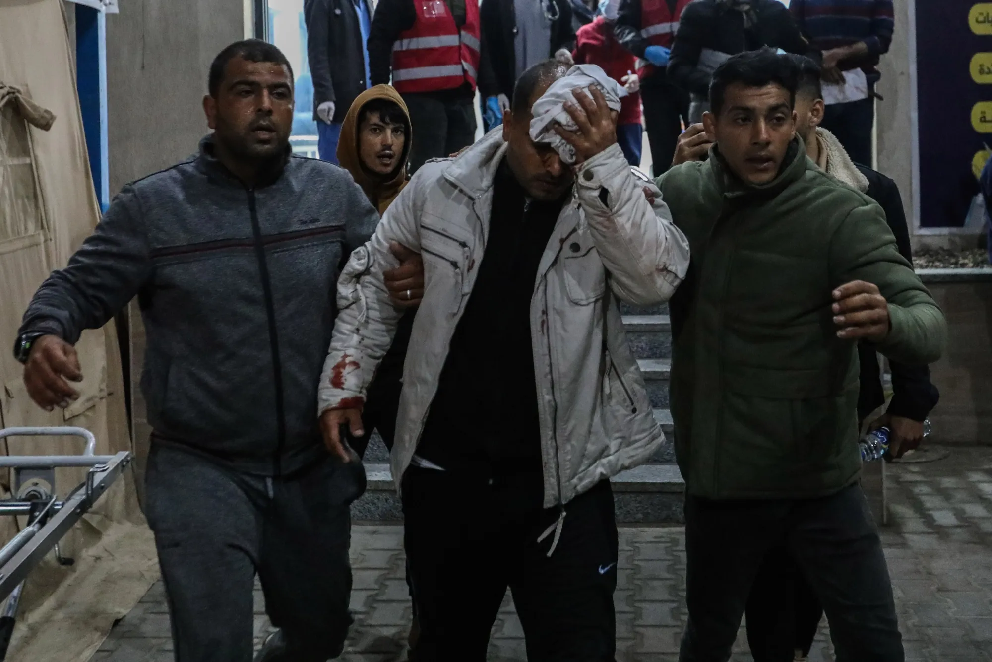 An injured man is led to Kuwait Hospital following air strikes in Rafah on Feb. 12.