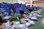 GUANGZHOU, Nov. 11, 2015 -- Workers sort out packages at a sorting center in Guangzhou, capital of south China's Guangdong Province, Nov. 11, 2015. The Singles' Day Shopping Spree, or Double-11 Shopping Spree, Chinese equivalent of Cyber Monday or Black Friday, is an annual online shopping spree falling on Nov. 11 for Chinese consumers since 2009. Each year the express delivery industry will face package peak after the shopping spree. (Xinhua/Liang Xu via Getty Images)
