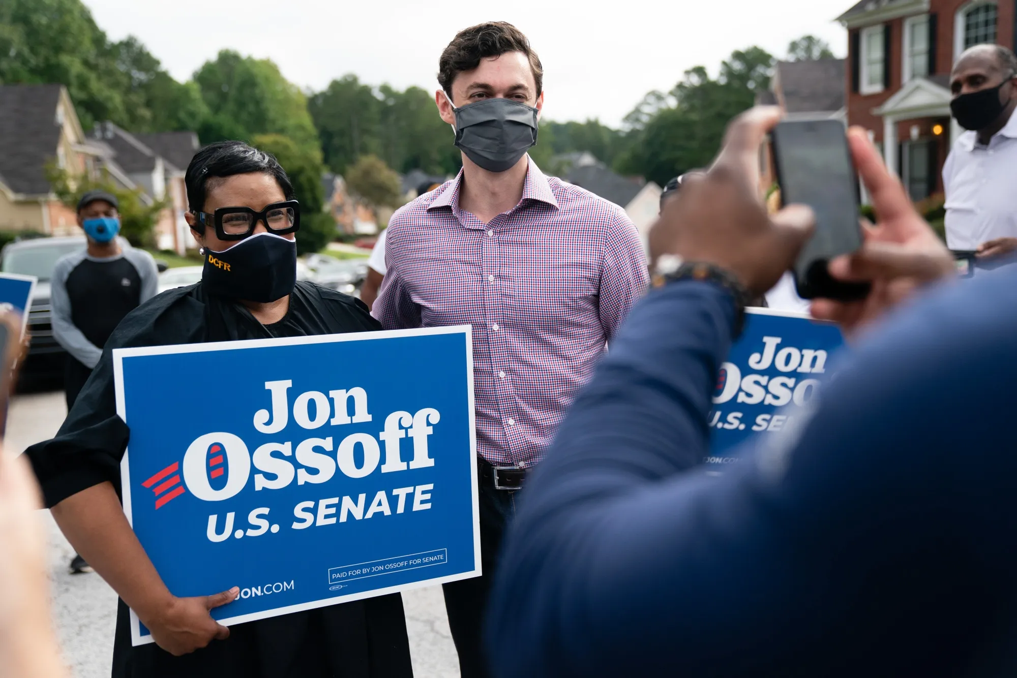 Jon Ossoff, U.S. Democratic Senate candidate, center, stands for a photograph with a supporter during a campaign event in Stone Mountain, Georgia on Sept. 26, 2020.