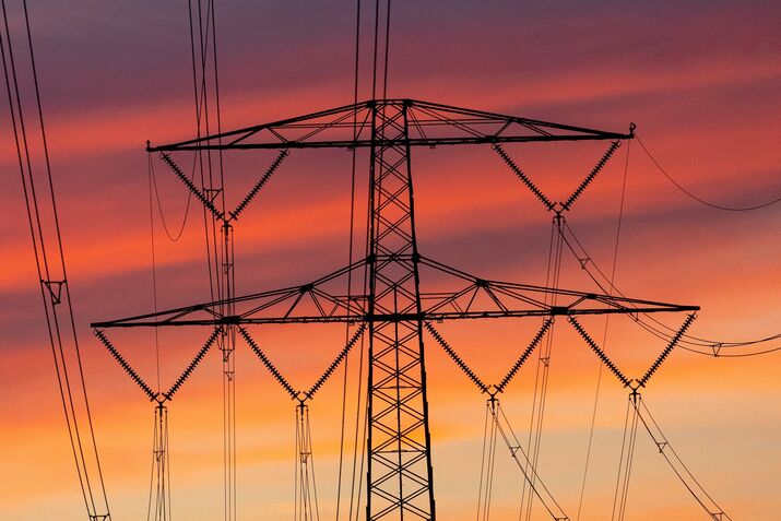 Electricity Pylon And Power Lines During Sunset