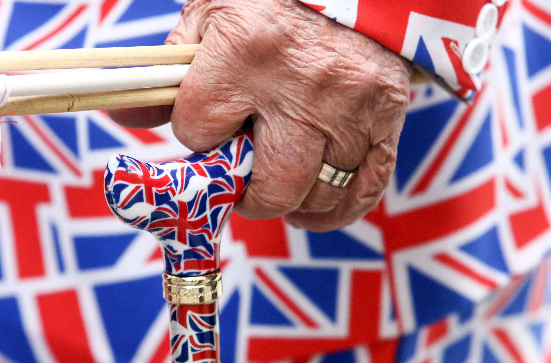 An elderly pedestrian holds a walking stick, featuring a pattern of a British Union flag, commonly known as a Union Jack, in London, U.K., on Friday, June 10, 2016. U.K. Prime Minister David Cameron said he'll hold a long-pledged referendum on the U.K.'s membership of the European Union on June 23.
