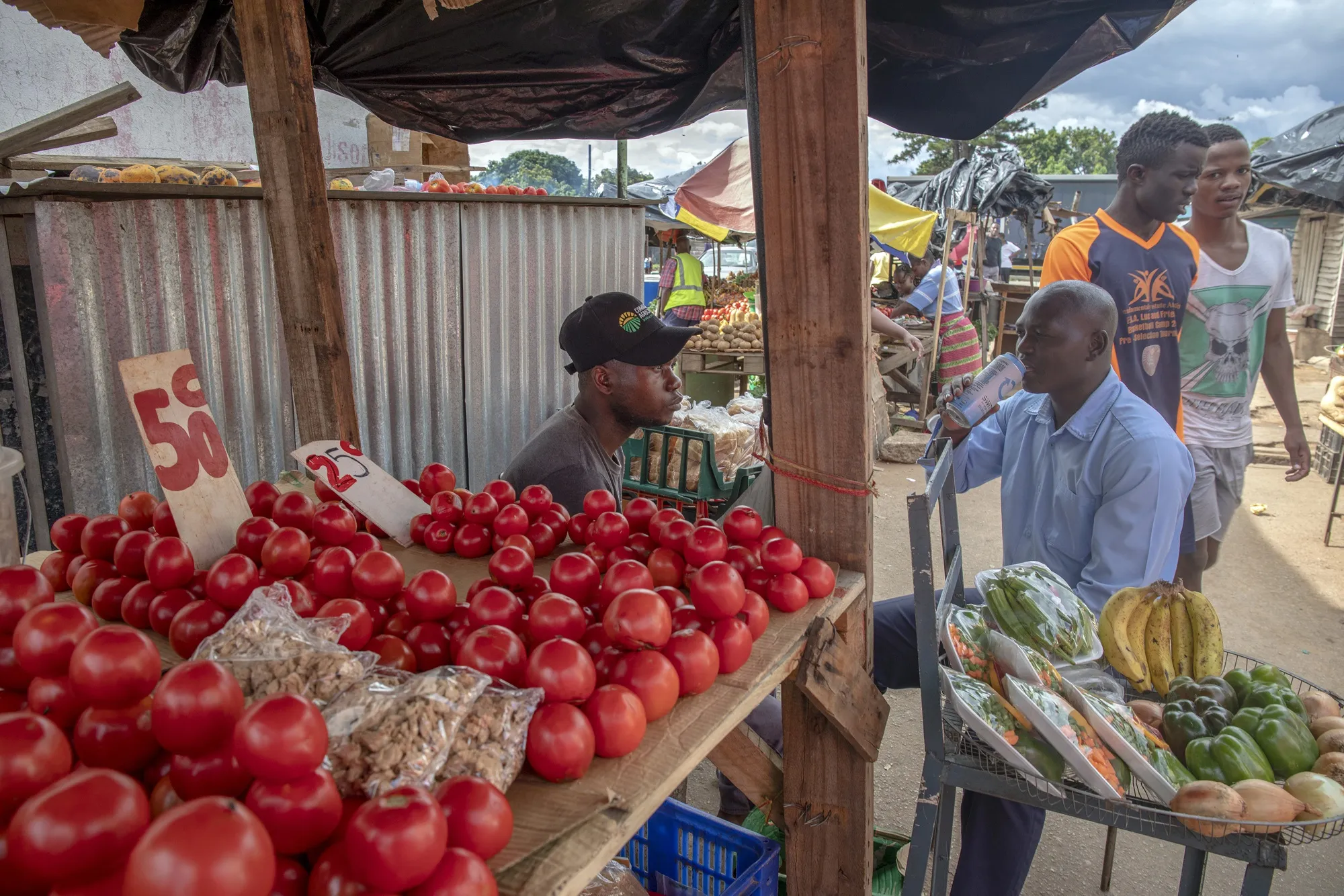 A vendor sells fresh fruit and vegetable at a market in Harare.