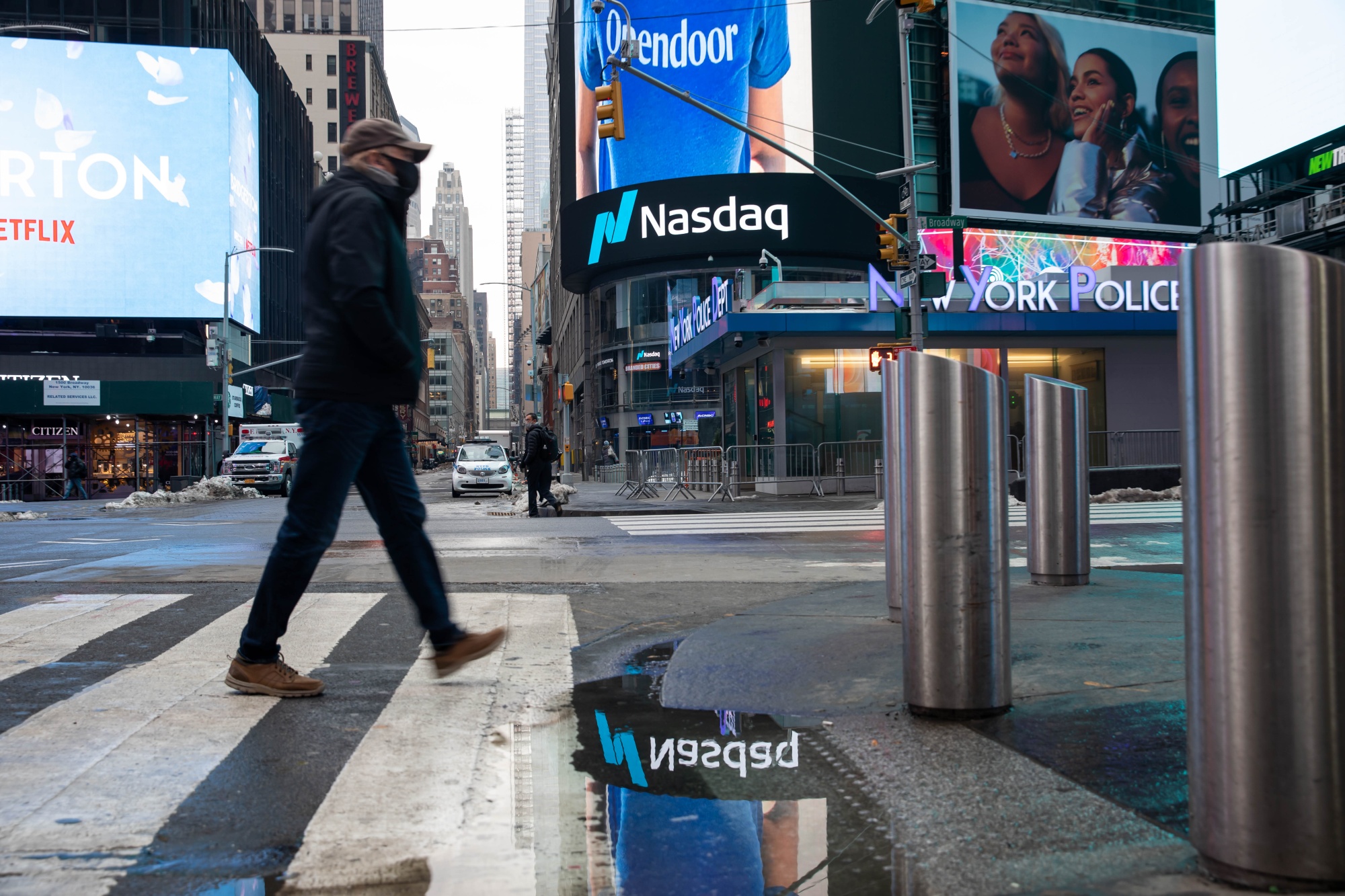 A pedestrian passes in front of Nasdaq MarketSite.
