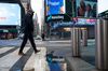 A pedestrian passes in front of the Nasdaq MarketSite.