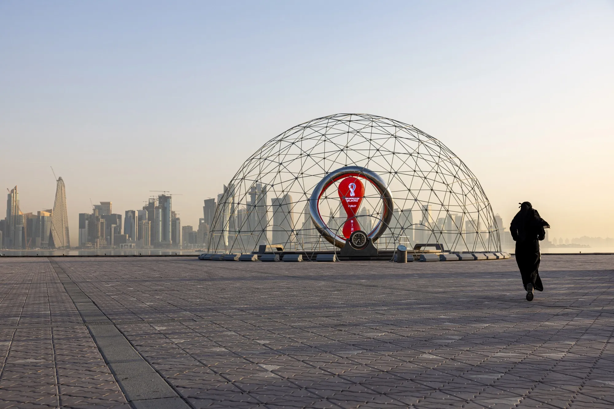 A resident jogs alongside a countdown installation for the upcoming 2022 FIFA World Cup in Doha, Qatar.