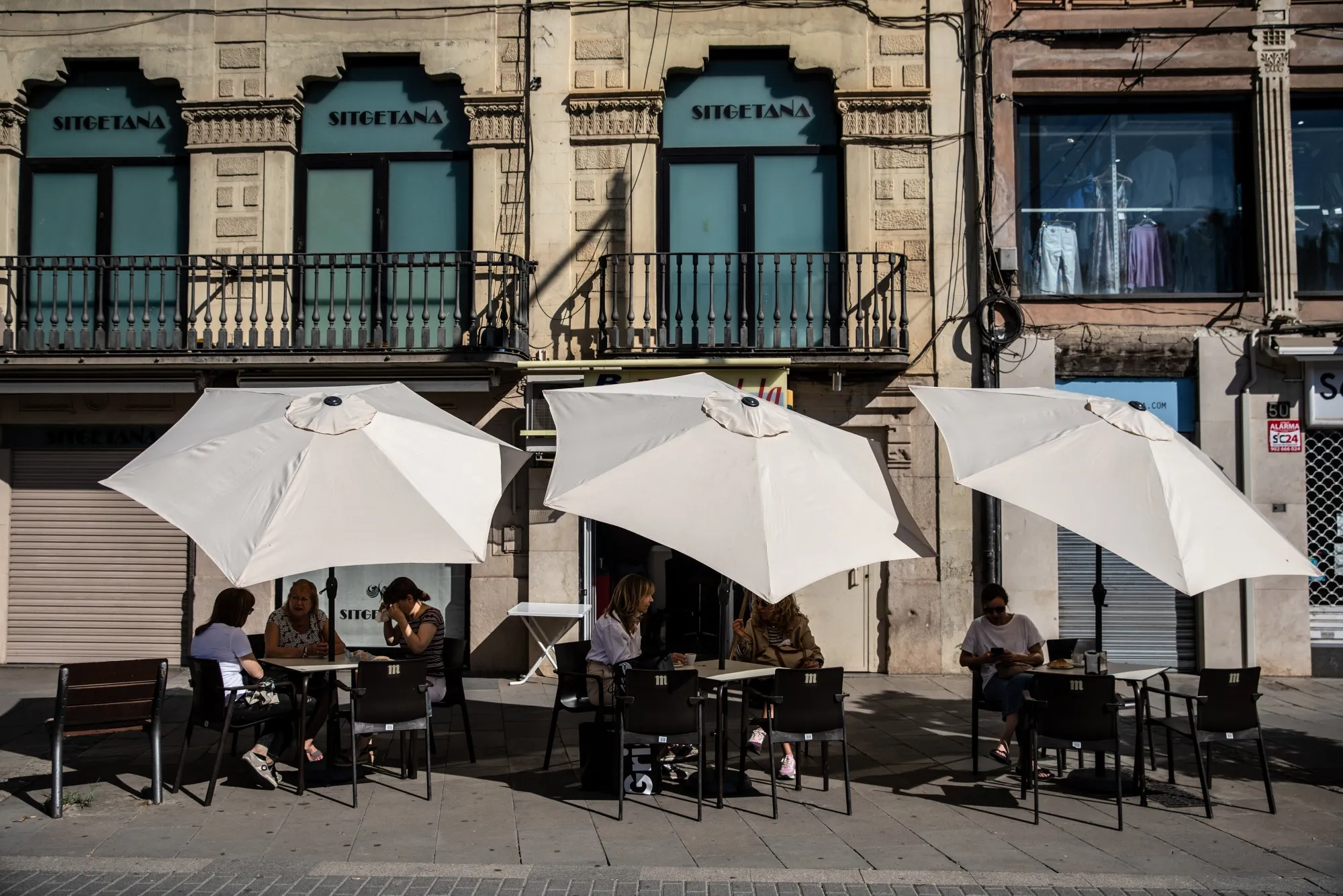 Customers shelter from the sun&nbsp;at a cafe&nbsp;in Lleida, Spain.
