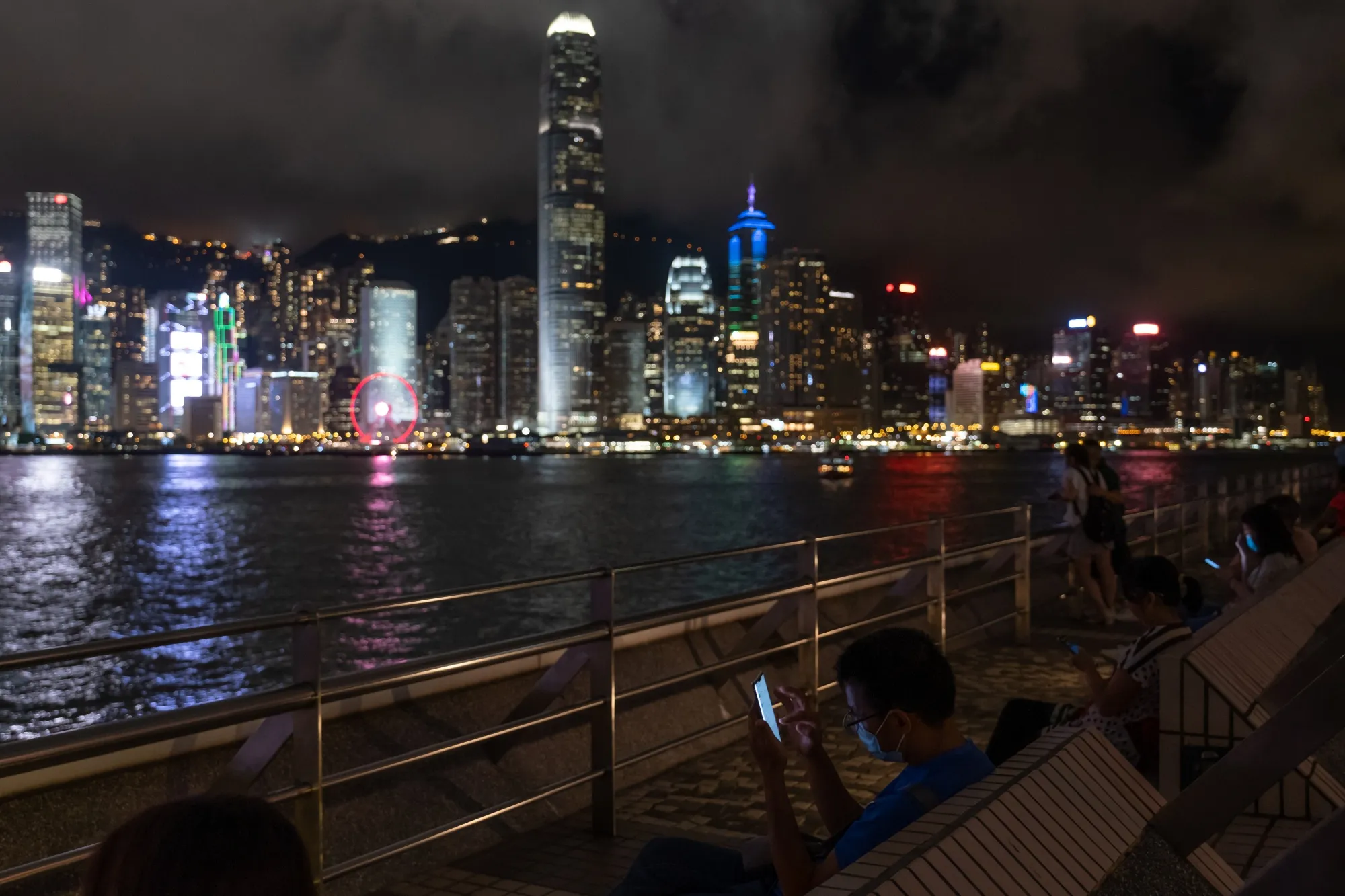 A person checks a smartphone along the Victoria Harbour waterfront in Tsim Sha Tsui in Hong Kong on&nbsp;July 7.