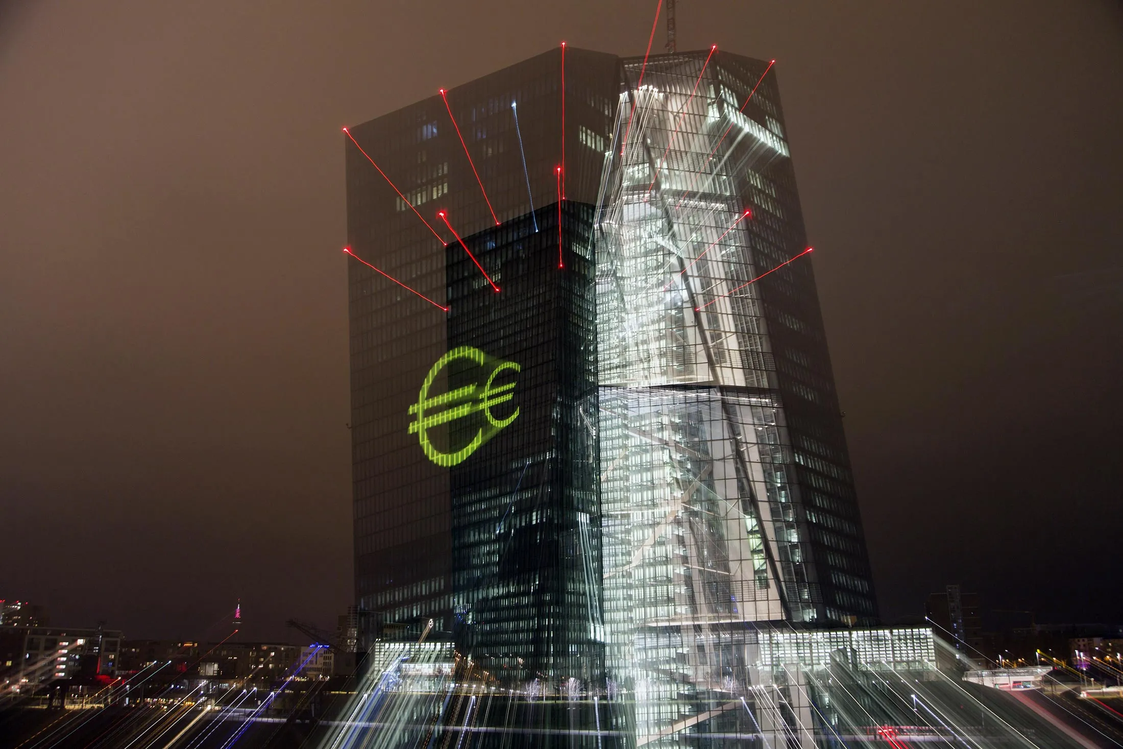An illuminated euro currency symbol is projected on to the European Central Bank (ECB) headquarters during a rehearsal for the Luminale light festival in Frankfurt, Germany, on Saturday, March 12, 2016. The Luminale 2016 light festival is scheduled to begin on March 13 and runs through March 18.
