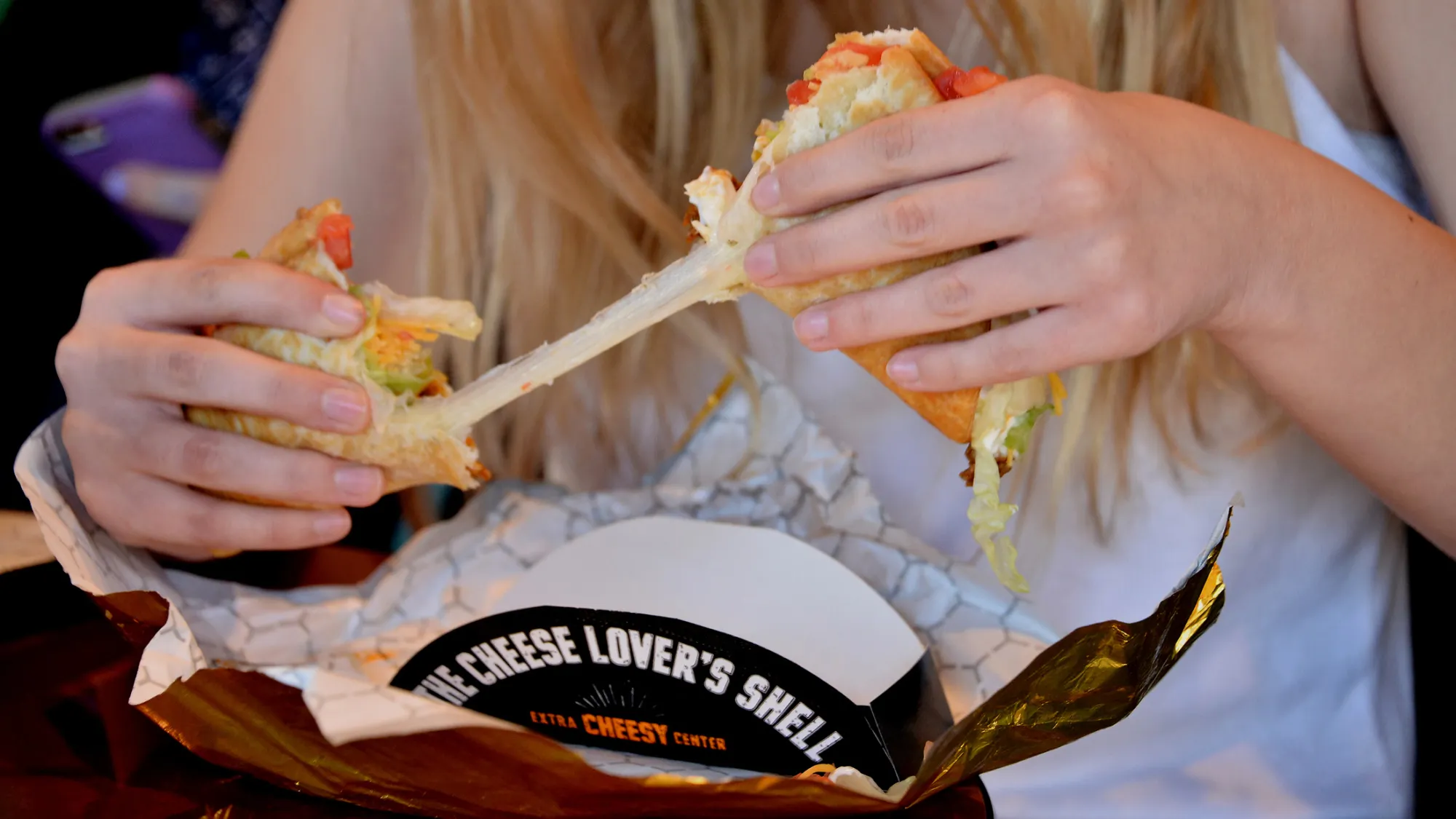 A customer pulls apart a Taco Bell Corp. Quesalupa.
