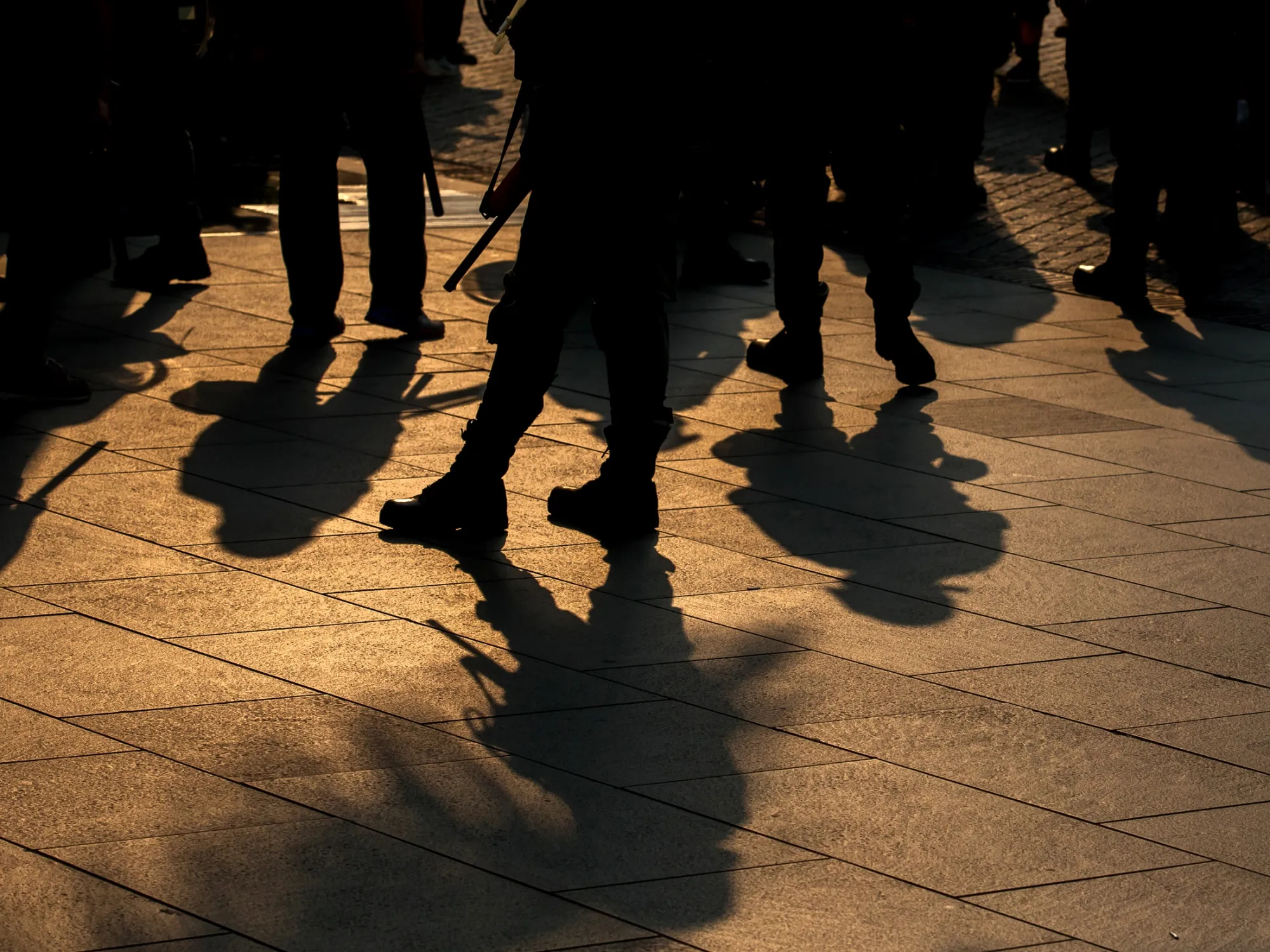 The shadows of riot police are cast on the ground during a protest in&nbsp;Hong Kong.