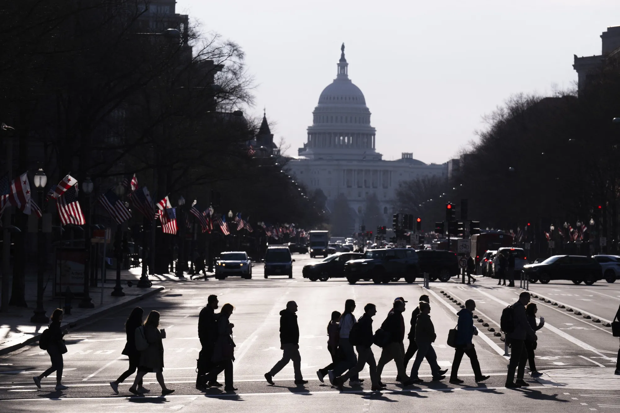 Commuters cross Pennsylvania Avenue in Washington.