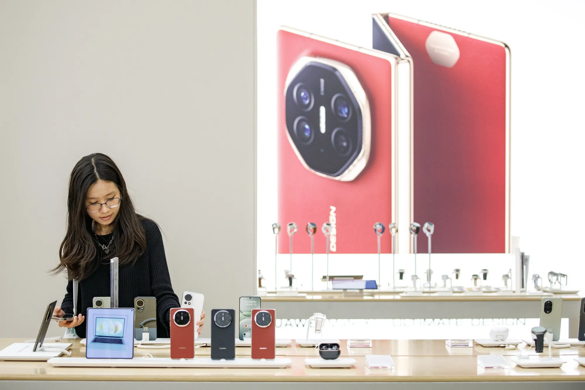 A visitor checks out a Huawei smartphones in a store in Kuala Lumpur.